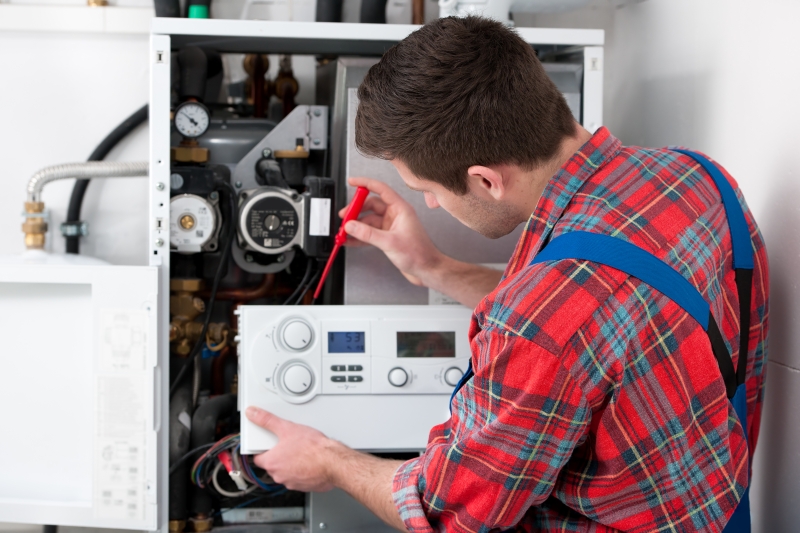 Gas Safe engineer working on a boiler in West Horsley